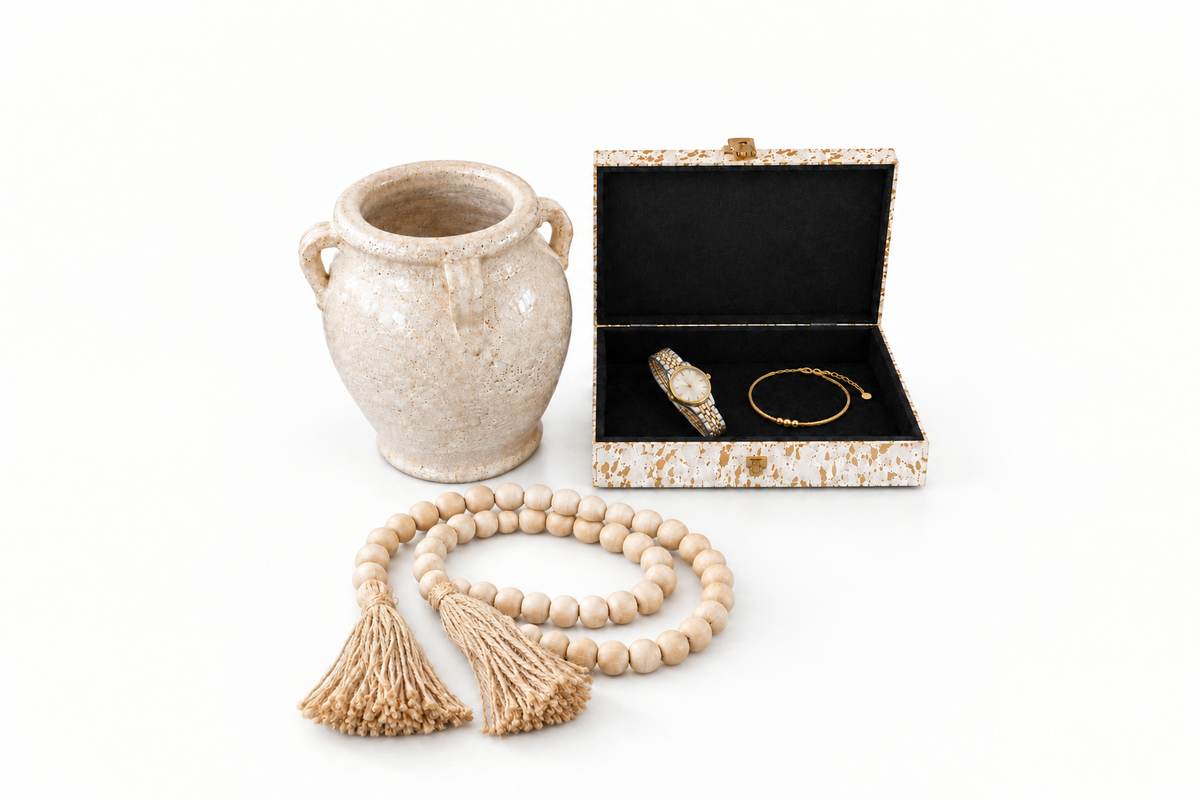 White crackle terracotta vase beside an open keepsake box with black painted wood interior and wood bead garland